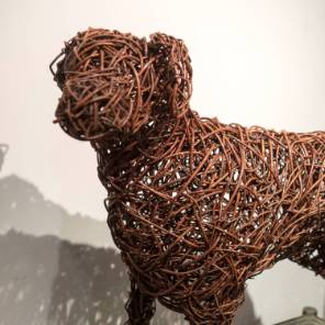 A life sized willow dog sculpture